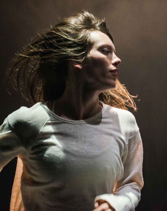 Woman captured in dance movement.