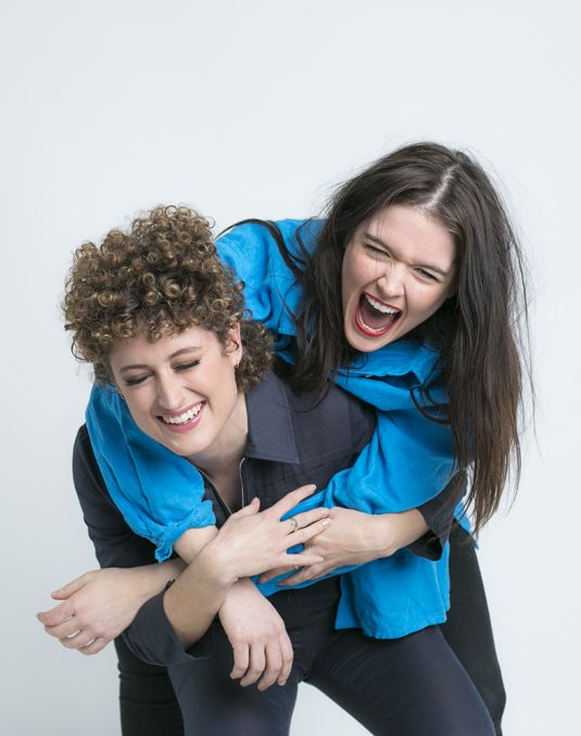 Woman giving another woman a piggyback. 