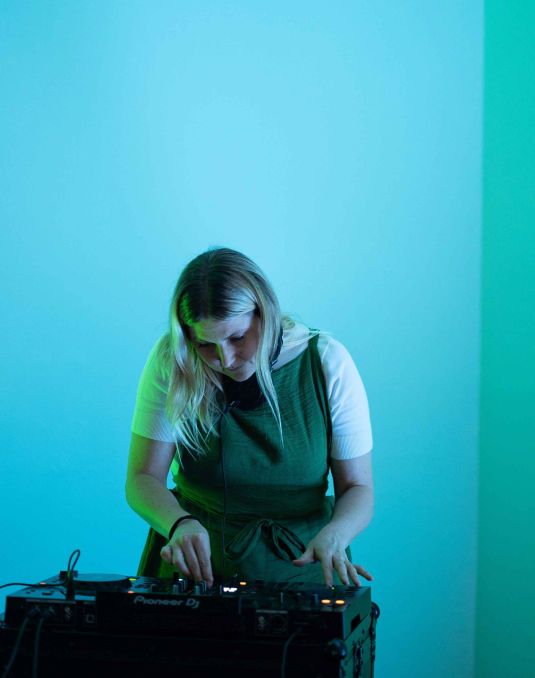 A person using an electronic music deck. 