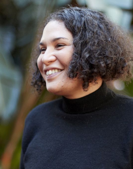 Headshot of Roberta Joy Rich. A smiling woman with chin length curly hair.