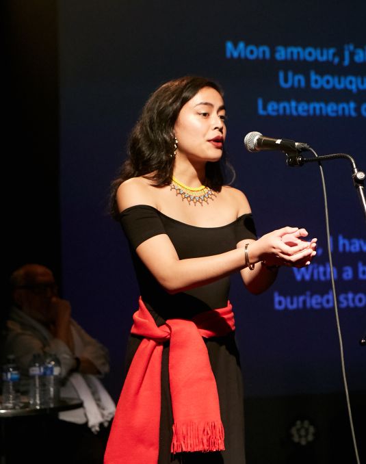 Woman speaking into a microphone.