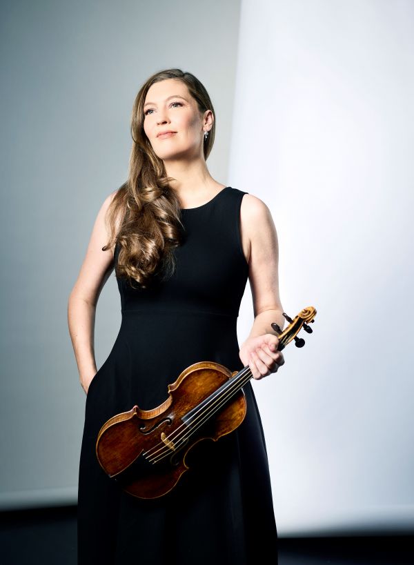 Woman holding violin against white background.