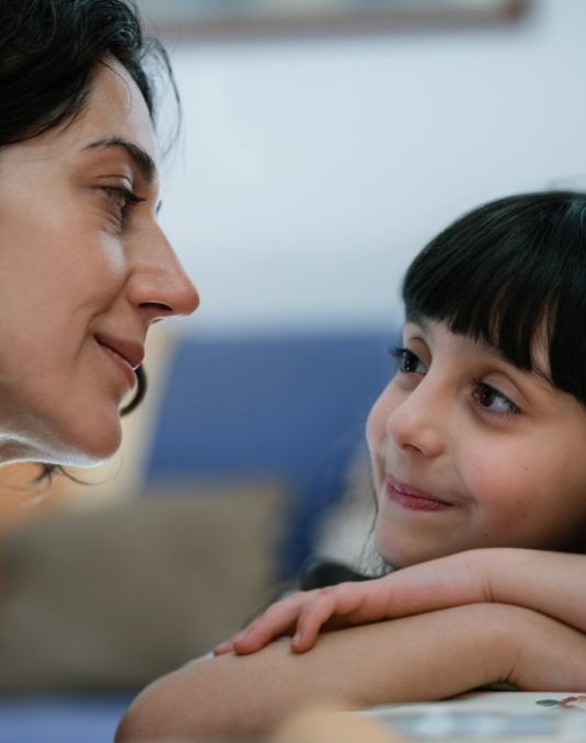 A woman and child gaze at each other lovingly. 