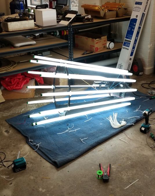 Sculpture on the ground with glowing lights. 